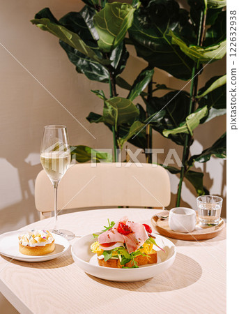 Delightful brunch spread featuring a vibrant salad and a sweet pastry in a cozy cafe setting Delightful brunch spread featuring a vibrant salad and a sweet pastry in a cozy cafe setting 122632938