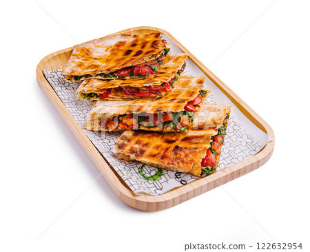 Deliciously grilled quesadillas filled with fresh vegetables on a serving tray Deliciously grilled quesadillas filled with fresh vegetables on a serving tray 122632954