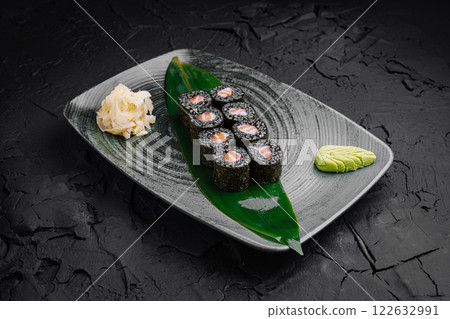 Fresh sushi rolls served on a decorative plate with wasabi and pickled ginger Fresh sushi rolls served on a decorative plate with wasabi and pickled ginger 122632991