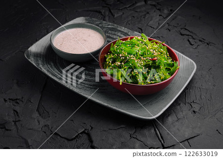 Fresh seaweed salad served with a creamy dressing on a stylish plate Fresh seaweed salad served with a creamy dressing on a stylish plate 122633019