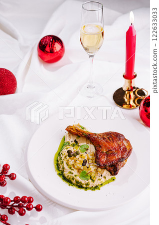 Delicious duck leg served with creamy mashed potatoes and festive decorations for a special occasion Delicious duck leg served with creamy mashed potatoes and festive decorations for a special occasion 122633033
