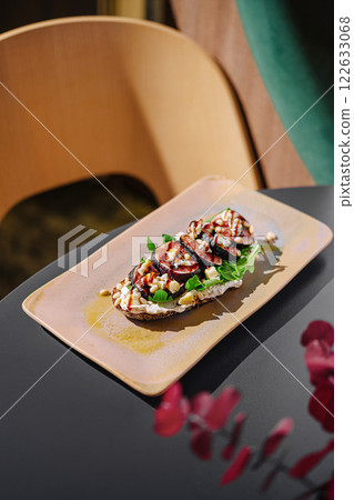 Delicious grilled vegetable dish served on a rustic plate in a modern dining space with natural light Delicious grilled vegetable dish served on a rustic plate in a modern dining space with natural light 122633068