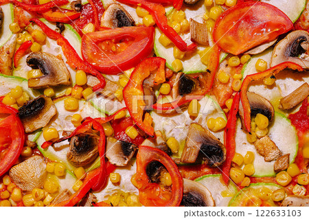 Colorful vegetable medley on a pizza with mushrooms, peppers, corn, and tomatoes arranged appealingly Colorful vegetable medley on a pizza with mushrooms, peppers, corn, and tomatoes arranged appealingly 122633103