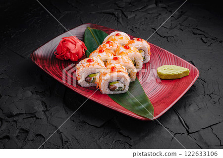 Delicious sushi rolls beautifully presented on a vibrant plate with a touch of greenery and garnishes Delicious sushi rolls beautifully presented on a vibrant plate with a touch of greenery and garnishes 122633106