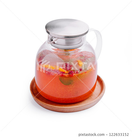 Refreshing beverage in a glass pitcher with vibrant fruit and herbs displayed on a wooden tray Refreshing beverage in a glass pitcher with vibrant fruit and herbs displayed on a wooden tray 122633152