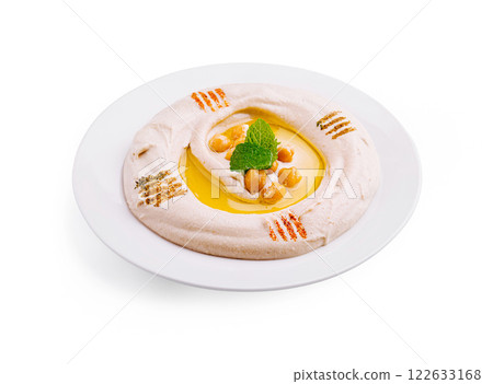 Creamy hummus served on a white plate garnished with chickpeas and olive oil 122633168