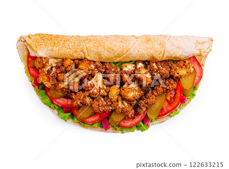 Delicious wrap filled with crispy cauliflower, fresh vegetables, and savory sauce in a whole grain tortilla 122633215
