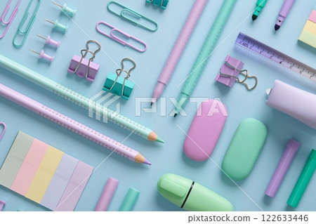 Stationery background with pastel-colored stationery neatly arranged on a light blue background. Back to school concept. Stationery background with pastel-colored stationery neatly arranged on a light blue background. Back to school concept. 122633446