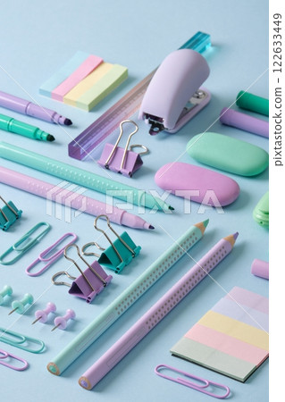 Stationery background with pastel-colored stationery neatly arranged on a light blue background. Back to school concept. Stationery background with pastel-colored stationery neatly arranged on a light blue background. Back to school concept. 122633449
