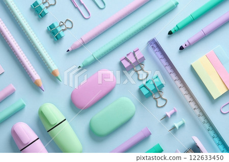 Stationery background with pastel-colored stationery neatly arranged on a light blue background. Back to school concept. 122633450