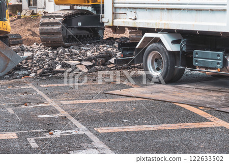 Demolition site: Heavy machinery for processing rubble and industrial waste collection vehicles Demolition site: Heavy machinery for processing rubble and industrial waste collection vehicles 122633502