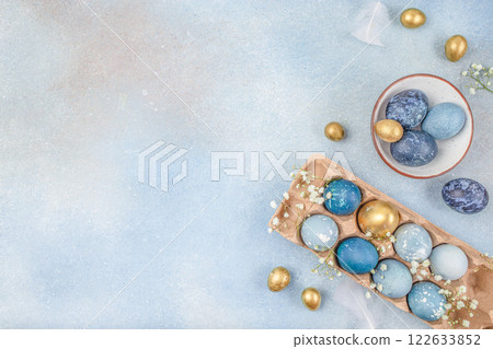 blue and golden eggs on a blue background. Easter card. top view. copy space blue and golden eggs on a blue background. Easter card. top view. copy space 122633852