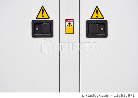 Metal doors with two locks, electric shock hazard sign zone Metal doors with two locks, electric shock hazard sign zone 122633971