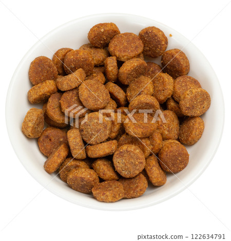Dry dog food in the white bowl. 122634791
