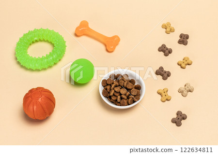 Pet supplies and playful items including a toy and dry food for dogs. 122634811