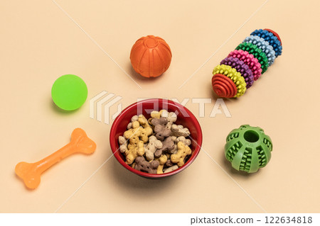 Pet supplies and playful items including a toy and dry food for dogs. 122634818