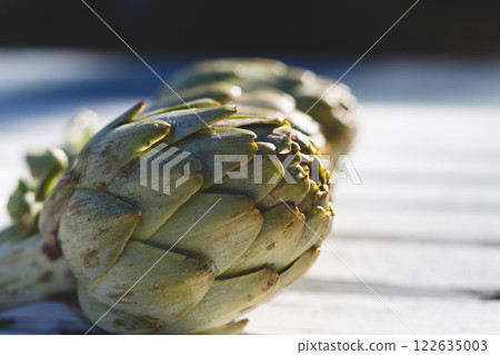 Fresh Artichokes on a Wooden Surface Display Fresh Artichokes on a Wooden Surface Display 122635003
