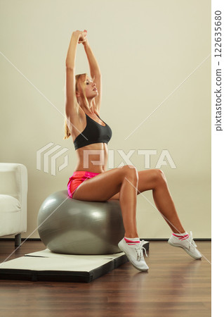 woman doing fitness exercises with fit ball woman doing fitness exercises with fit ball 122635680