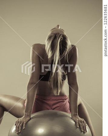 woman doing fitness exercises with fit ball 122635681