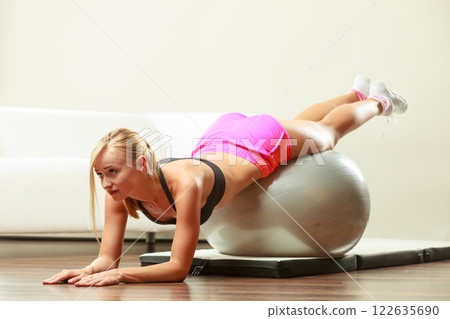 woman doing fitness exercises with fit ball woman doing fitness exercises with fit ball 122635690