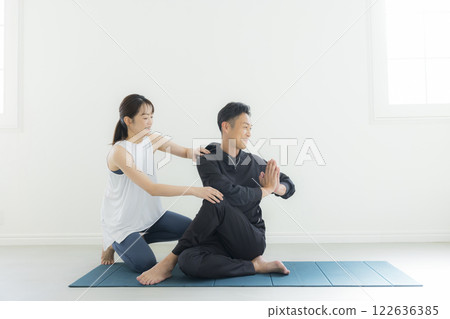 Man and woman doing yoga Man and woman doing yoga 122636385