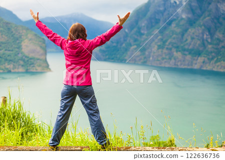 Woman with raised hands in norwegian mountains fjords 122636736