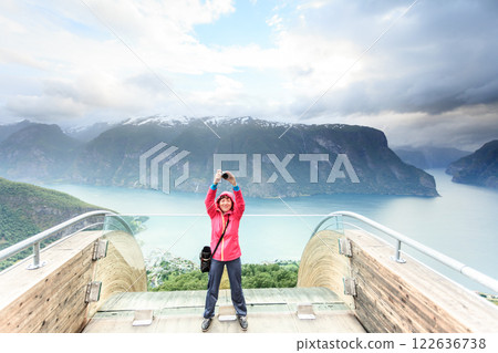 Tourist photographer with camera on Stegastein lookout, Norway Tourist photographer with camera on Stegastein lookout, Norway 122636738