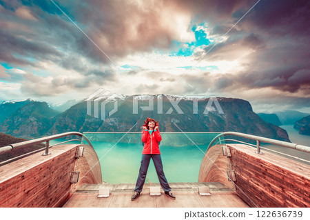 Tourist on Stegastein viewpoint, Norway Tourist on Stegastein viewpoint, Norway 122636739