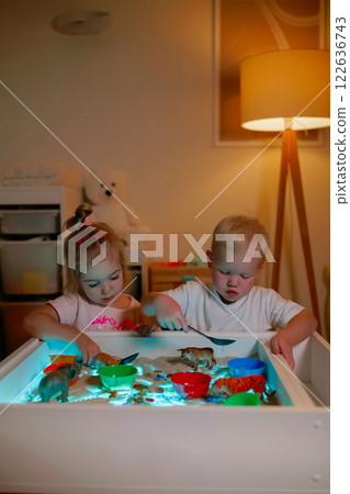 Preschoolers playing on sensory box. 122636743