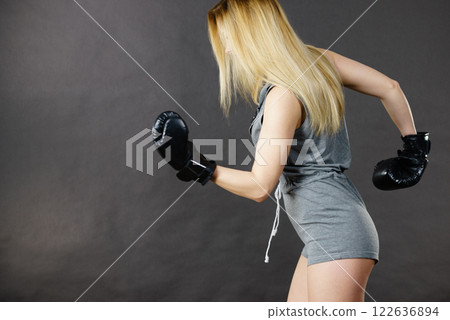 Boxer girl exercise with boxing gloves. 122636894