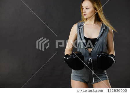 Boxer girl exercise with boxing gloves. 122636900