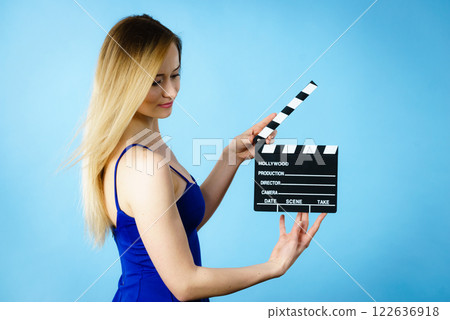 Woman holding professional film slate 122636918