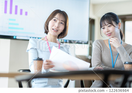 A young businesswoman having a meeting while holding documents A young businesswoman having a meeting while holding documents 122636984