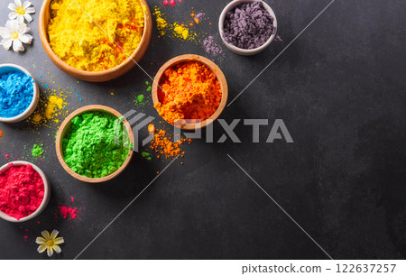Happy Holi decoration, the indian festival.Top view of colorful holi powder on dark background. Happy Holi decoration, the indian festival.Top view of colorful holi powder on dark background. 122637257