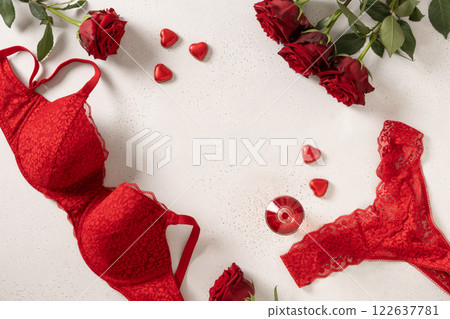Valentine's day frame with red lace bustier underwear, candy sweets and red roses on white background. Love. View from above. Copy space. Romantic dating. Valentine's day frame with red lace bustier underwear, candy sweets and red roses on white background. Love. View from above. Copy space. Romantic dating. 122637781