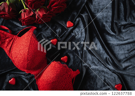 Lace women's red underwear, lingerie, chocolate candy sweets and red roses for Valentine's day on dark. Romantic dating. View from above. Copy space. Lace women's red underwear, lingerie, chocolate candy sweets and red roses for Valentine's day on dark. Romantic dating. View from above. Copy space. 122637788