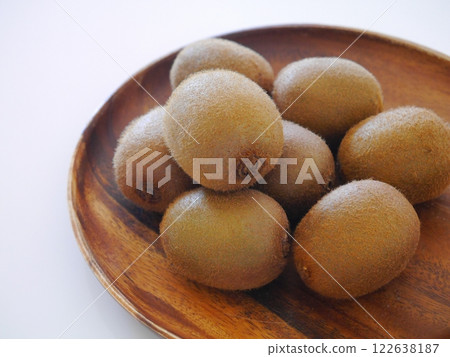 Kiwi fruit on a wooden plate Kiwi fruit on a wooden plate 122638187