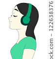 A woman listening to music with headphones 122638376