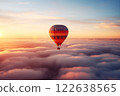 Colorful hot air balloon floats over a sea of clouds at sunset 122638565