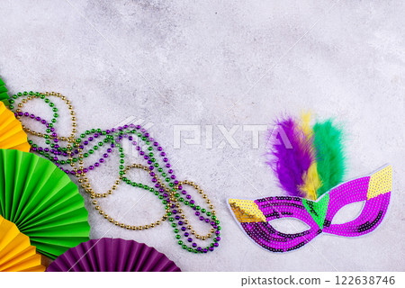 Vibrant Mardi Gras background with mask, beads, and festive decorations Vibrant Mardi Gras background with mask, beads, and festive decorations 122638746