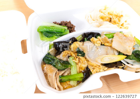 Delicious Chinese dish of fried pork and vegetables with egg and rice 122639727