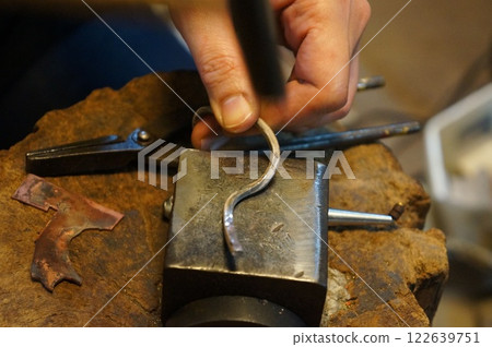 Craftsman working in a metal engraving studio Craftsman working in a metal engraving studio 122639751