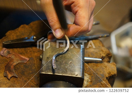 Craftsman working in a metal engraving studio Craftsman working in a metal engraving studio 122639752
