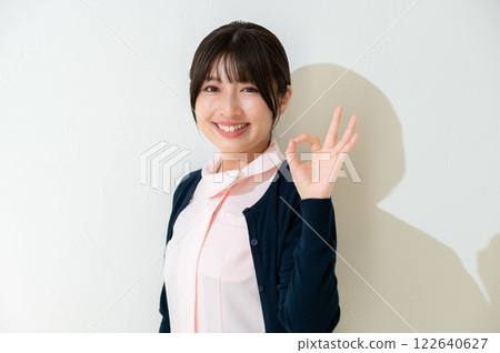 Japanese female staff making an OK pose Japanese female staff making an OK pose 122640627