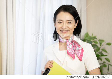 Esthetician smiling with a file Esthetician smiling with a file 122640752