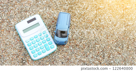 Small car model sits next to a calculator, symbolizing financial planning, insurance, budgeting, and car ownership. It represents vehicle costs, loans, and responsible investment. Small car model sits next to a calculator, symbolizing financial planning, insurance, budgeting, and car ownership. It represents vehicle costs, loans, and responsible investment. 122640800