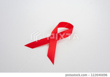 Red awareness ribbon symbol against white background. National Youth HIV and AIDS Awareness Day 122640896