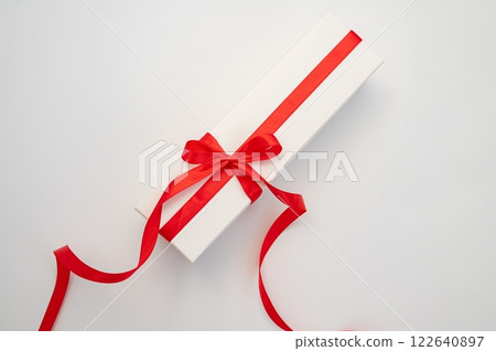 Elegant white gift box with red ribbon on clean background 122640897