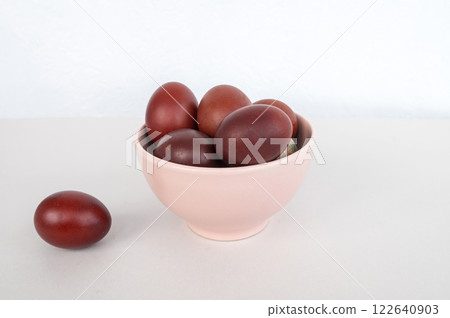 Bowl of brown eggs on white surface 122640903