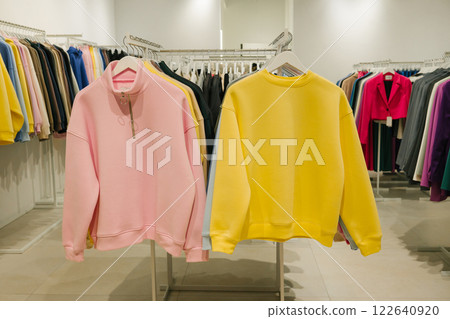 Pastel pink and yellow sweatshirts in modern clothing store display. Last-Minute Shopper's Day Pastel pink and yellow sweatshirts in modern clothing store display. Last-Minute Shopper's Day 122640920